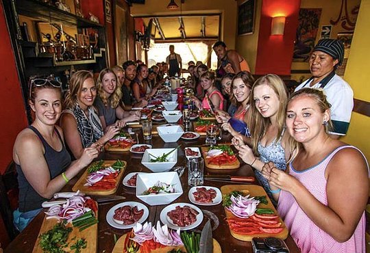 Cooking class finishing up their food prep on their Peru tour