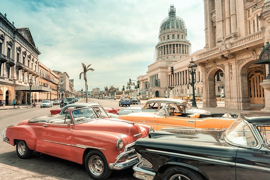 Cruise through Havana’s streets in a classic American convertible at sunset