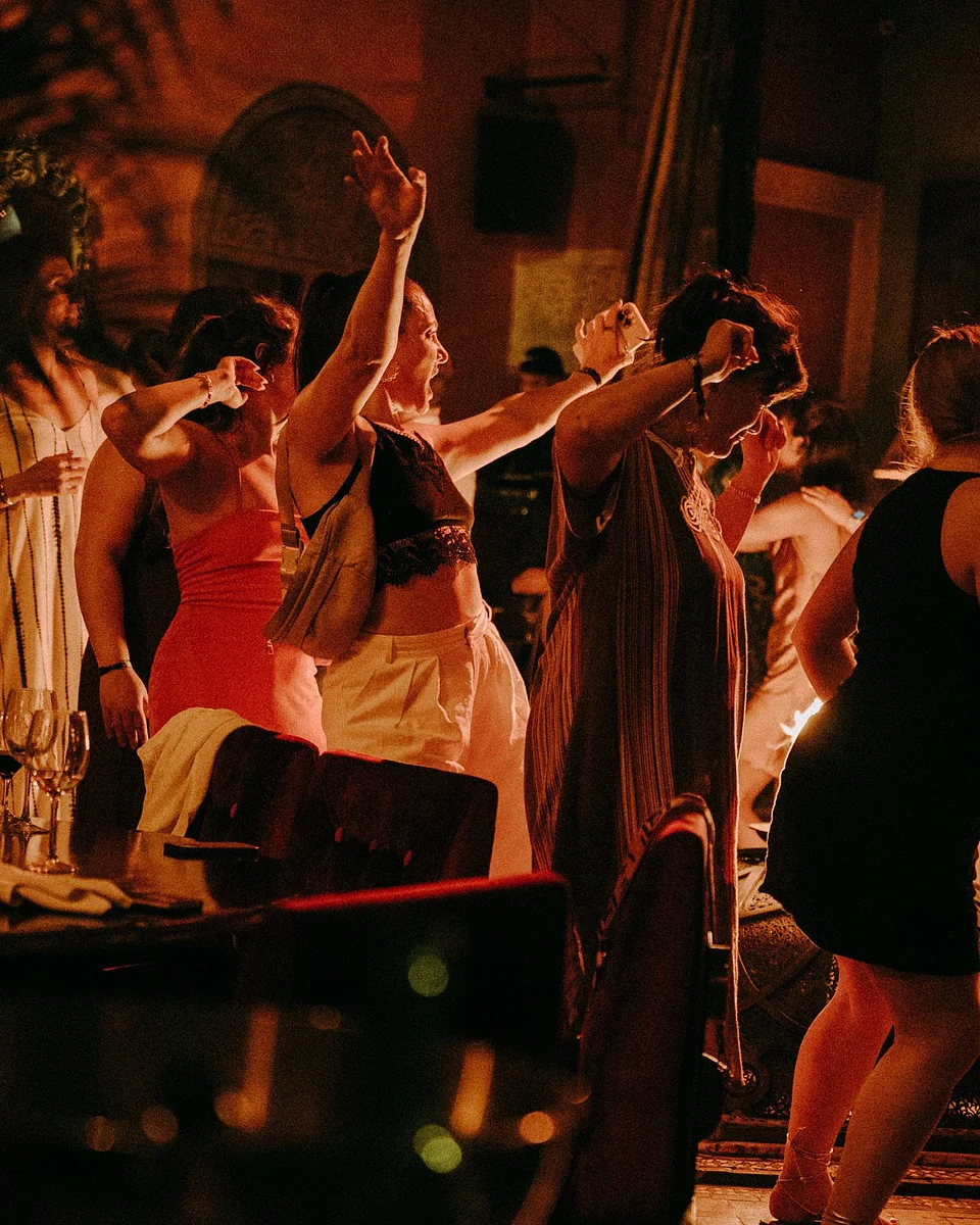 SYB travelers dancing at a party at night in the desert