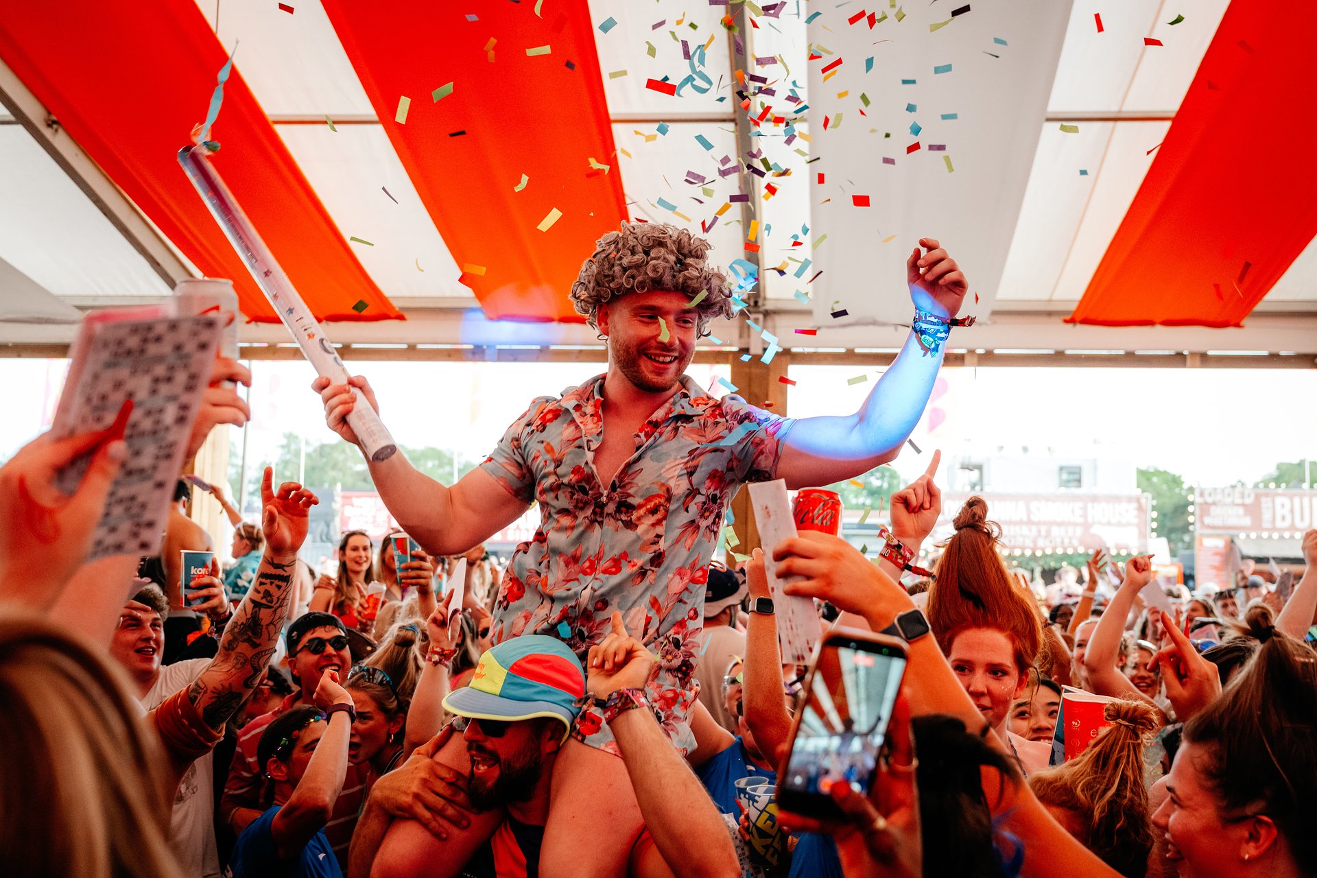 Bingo Lingo granny dancing on shoulders in the Beer Tent at Bournemouth 7s Festival in Dorset