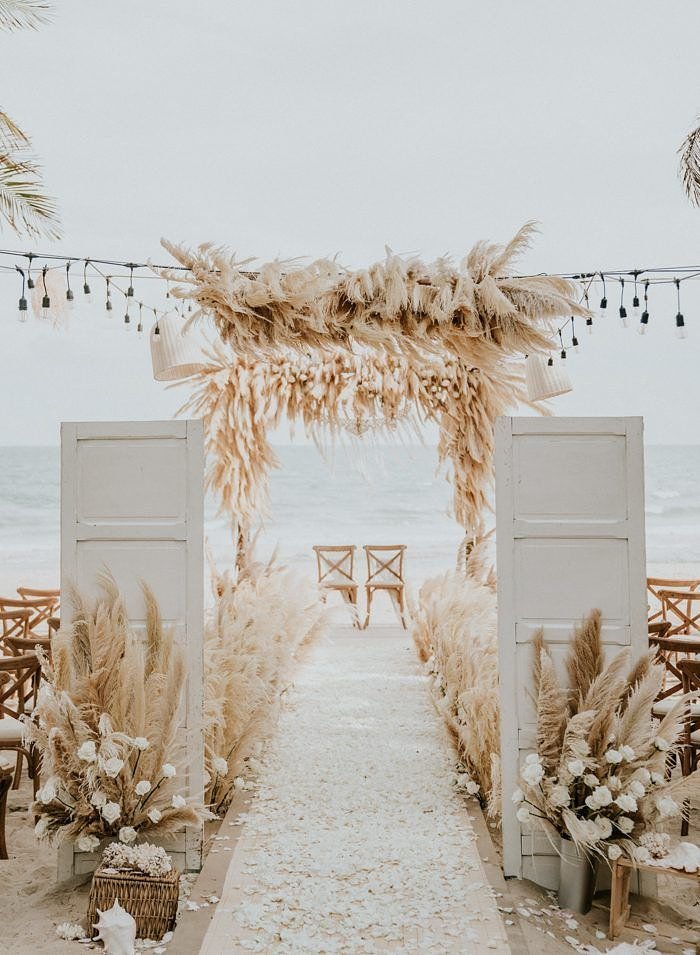 bohochicbeachweddingceremonyideaswithdoorsanddpampasgrass