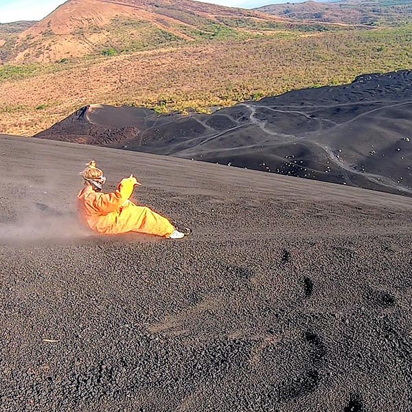 Traveller flying down a volcano in Leon_travel Nicaragua