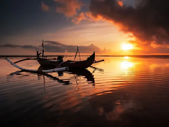 Gliding through the Balinese Sea on a sunset boat ride