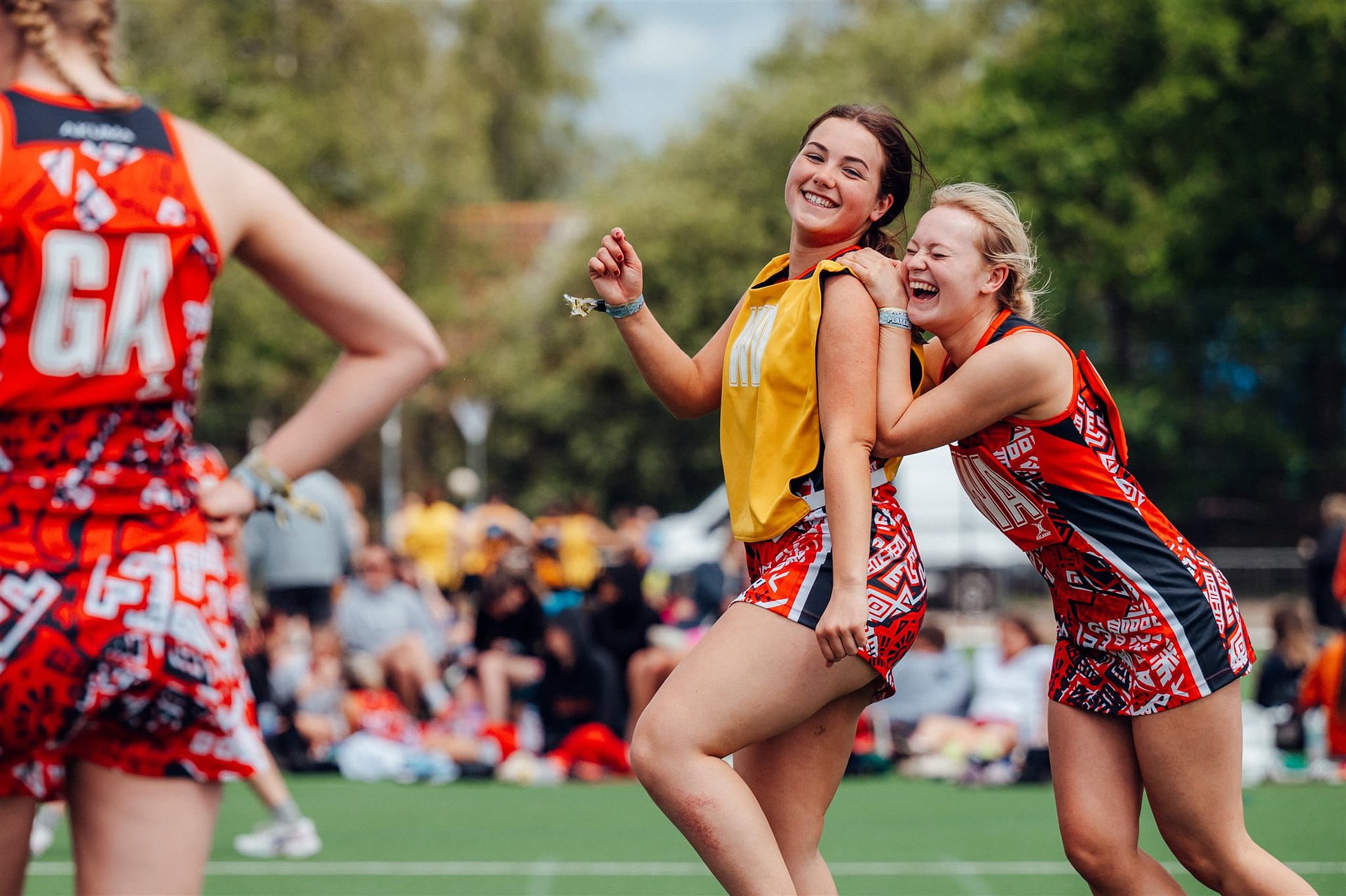 Netball players on tour having fun on the court at Bournemouth 7s Festival, in Dorset England.