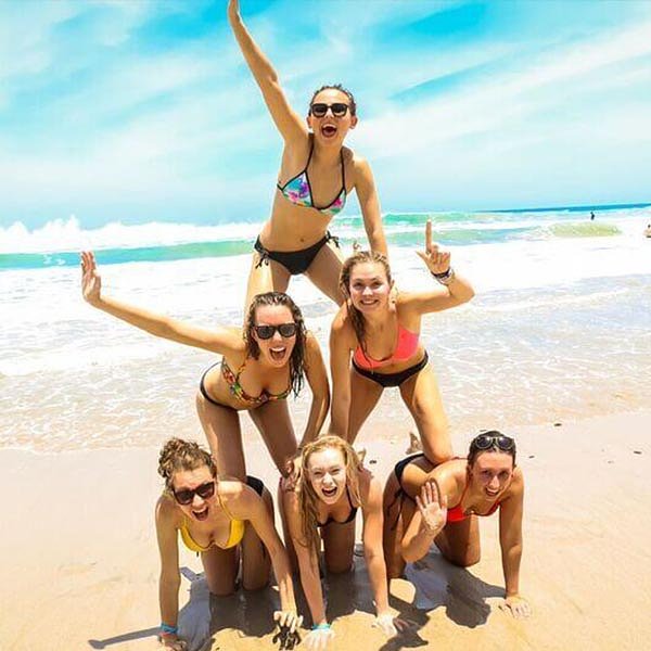 group of female travellers_doing a pyramid on beach in Costa Rica