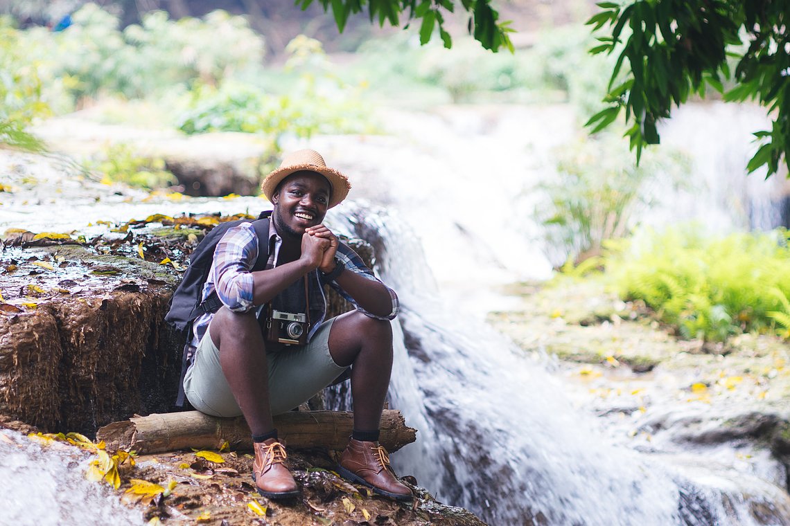 africanmantravelerrelaxingfreedomwaterfall