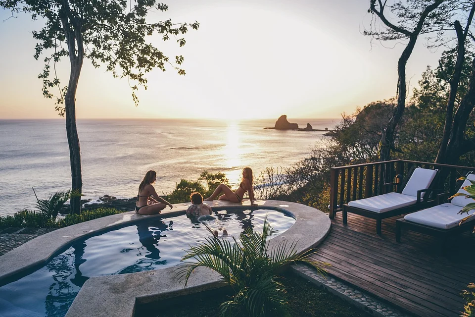 Travelers in a plunge pool at sunset at Villas Playa Maderas, Nicaragua