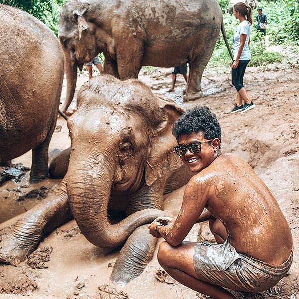 LBW tour guide in a mud bath with thai elephants