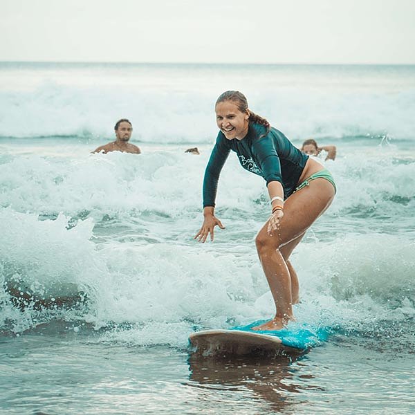 solo travel_female traveller surfing a wave in playa escameca Nicaragua