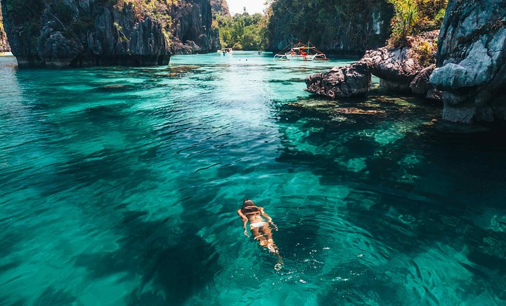 Puerto Princesa Philippines lagoon with woman swimming