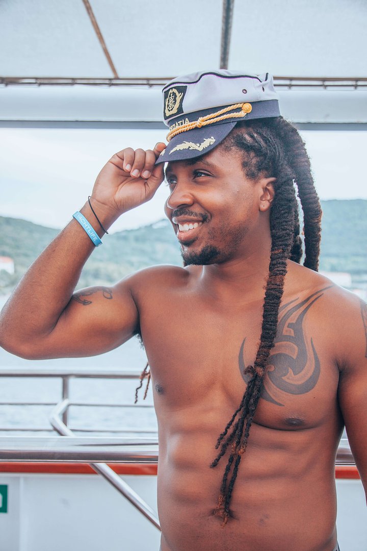 rasta man wearing a captains hat croatia sailing