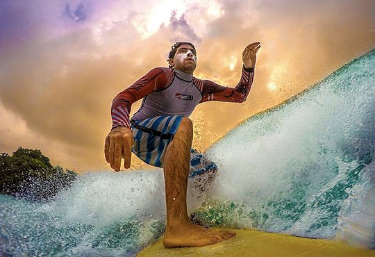 Male surfer riding the waves of Central America on an adventure tour