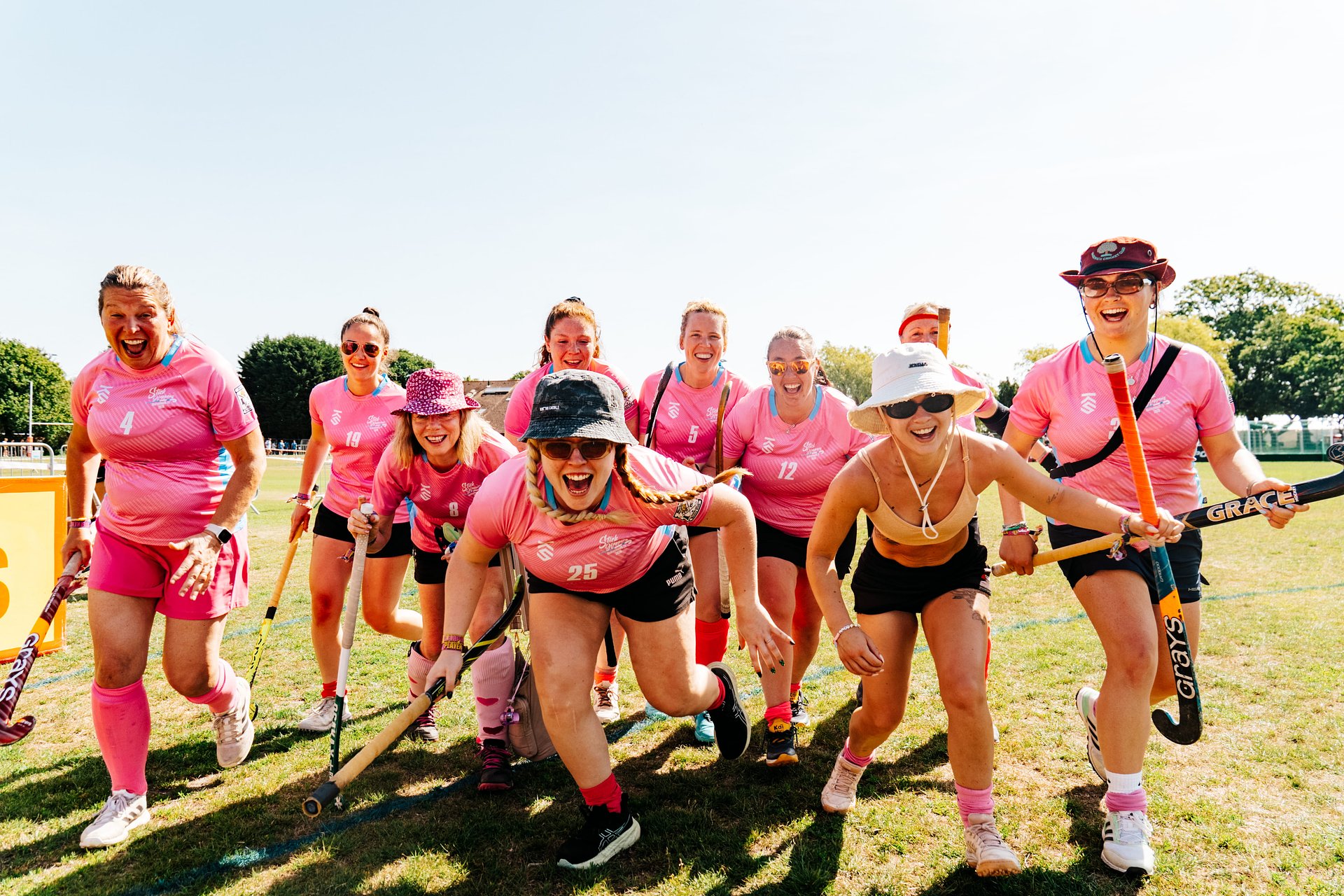 Ladies hockey team running towards the camera doing a tournament at Bournemouth 7s Festival, in Dorset England.