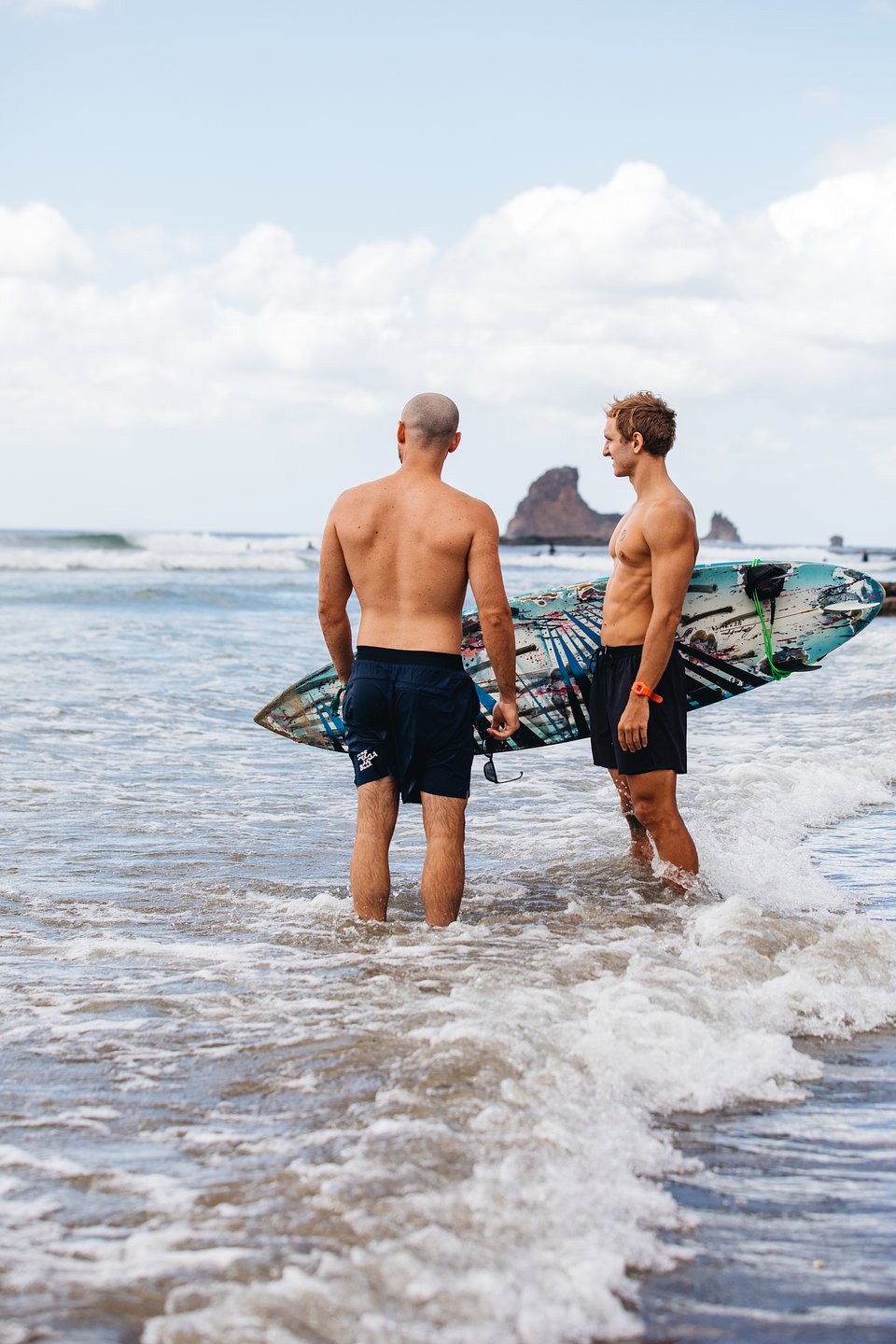 SurfYogaBeer crew with surfboards on the beach