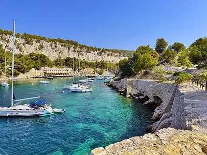 Yachts anchored in a turquoise calanque near Cassis