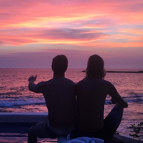 Two male surfers enjoying a sunset_Nicaragua tour