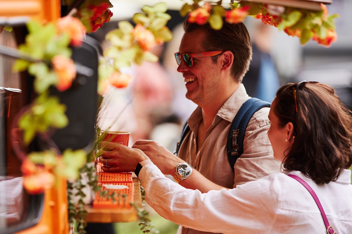 Happy visitors of Savour Festival 2023 receiving their amazing Aperol Spritzs at the Little Orange Van 