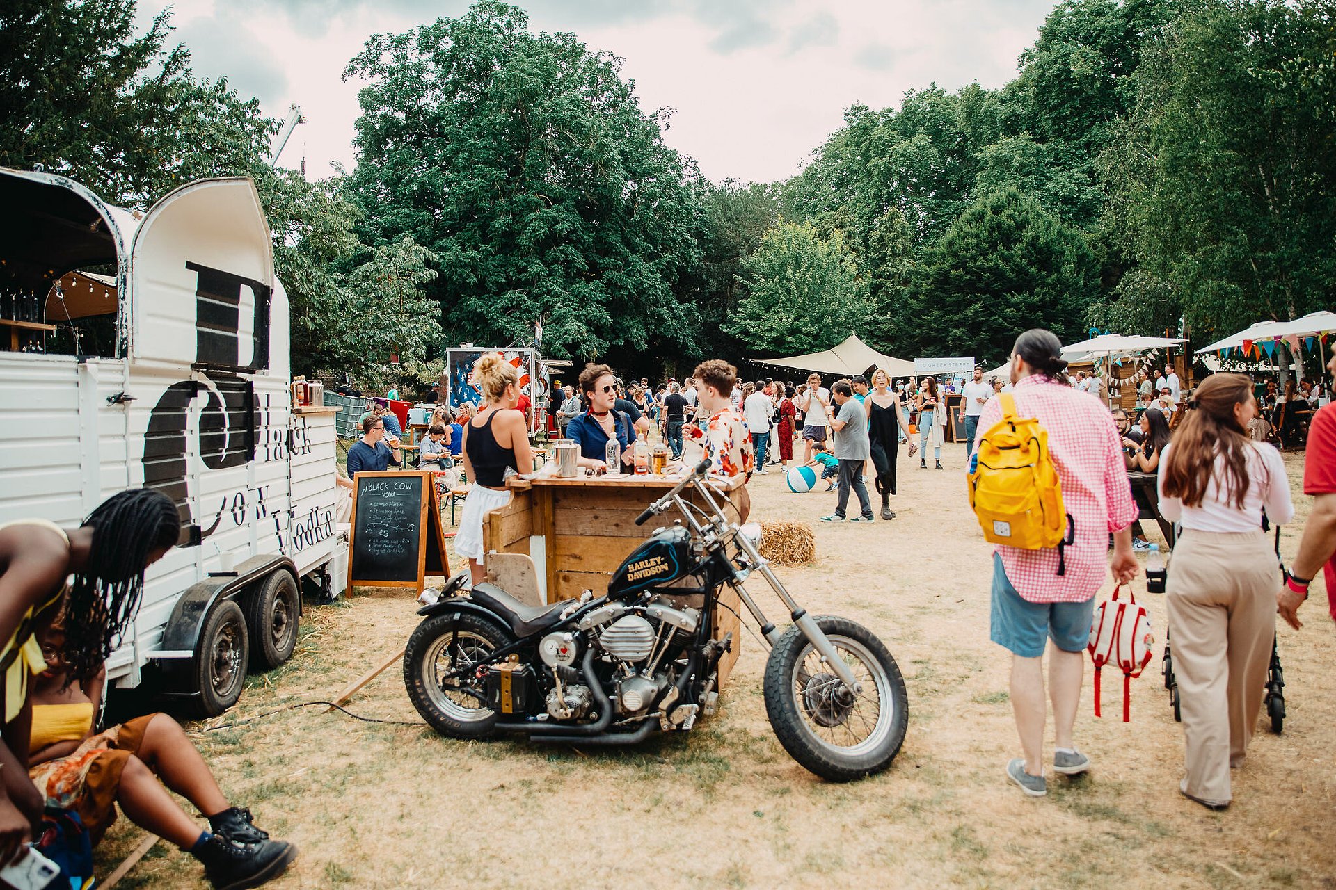 A crowd of people and food trucks at the Royal hospital chelsea London 