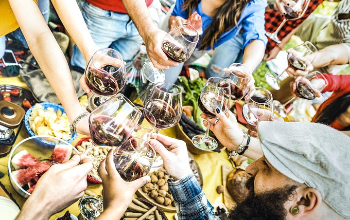 topviewoffriendhandstoastingredwineglassa20240703024410utc