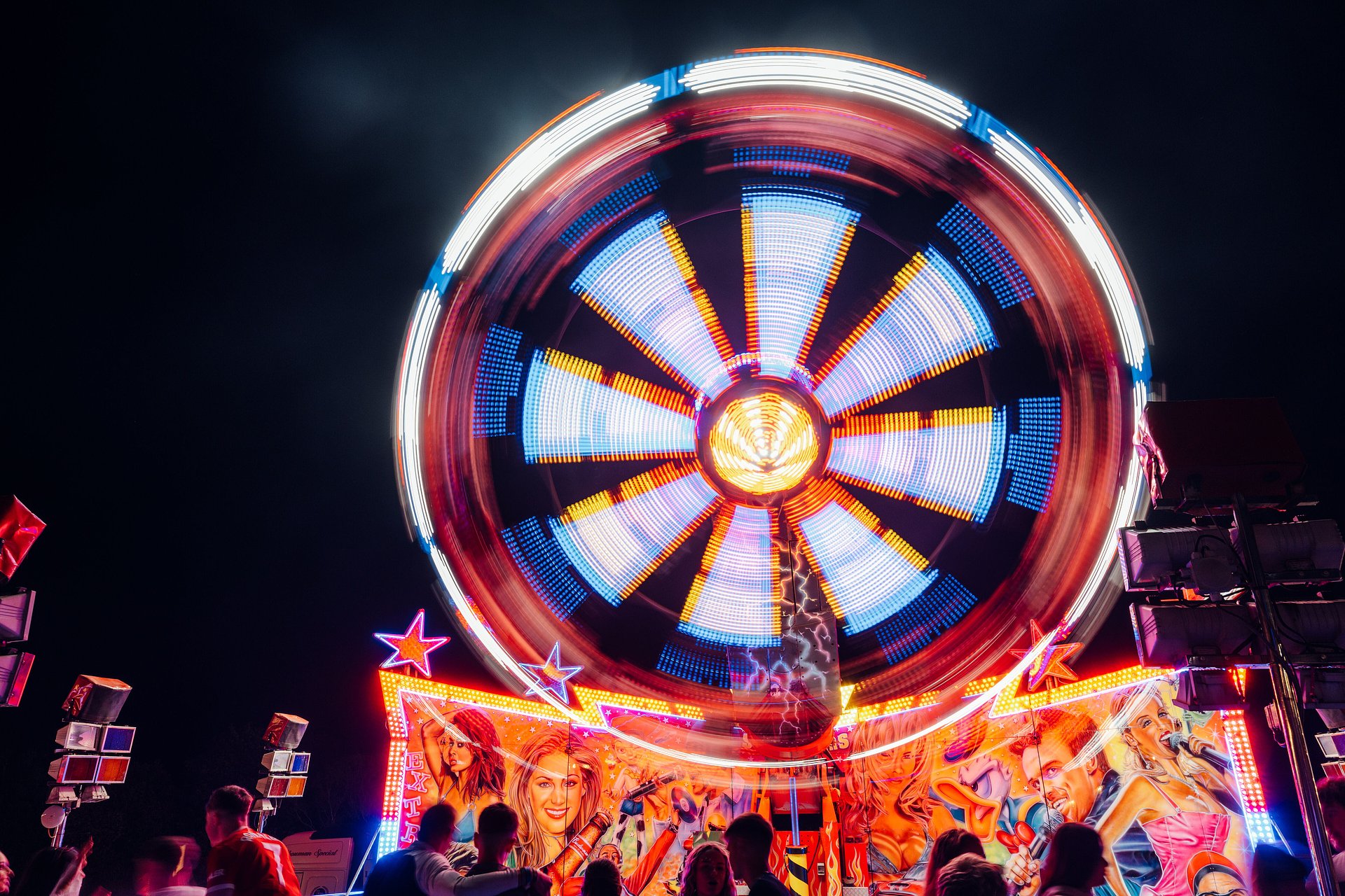 Funfair ride is lit up at night as it spins around at Bournemouth 7s Festival in Dorset