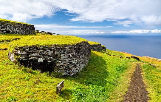 Wander through Orongo Ceremonial Village, an ancient hillside stone village