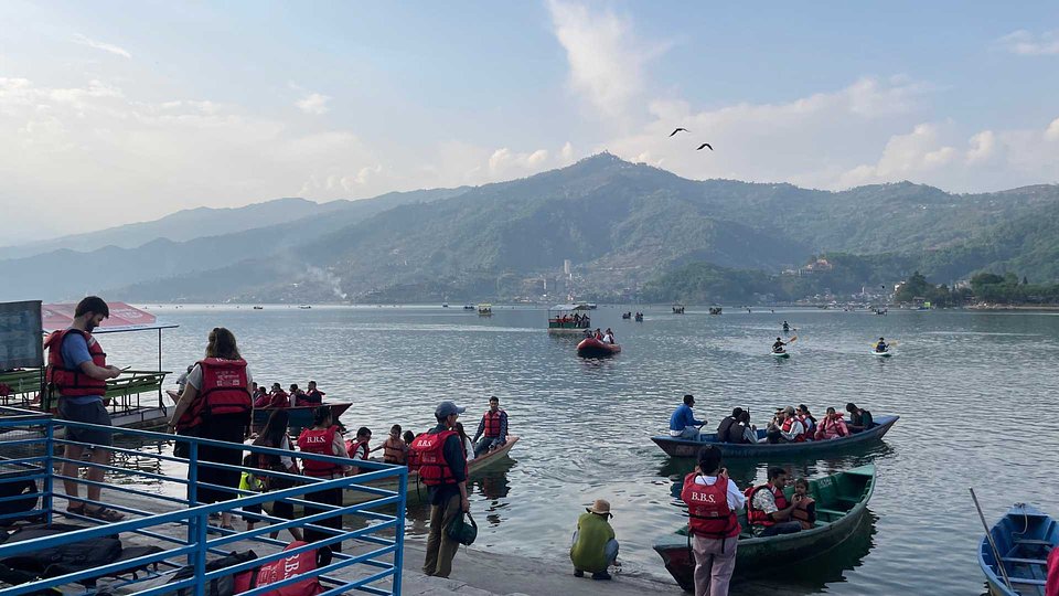 Boats and swimmers on Phewa Lake, Pokhara