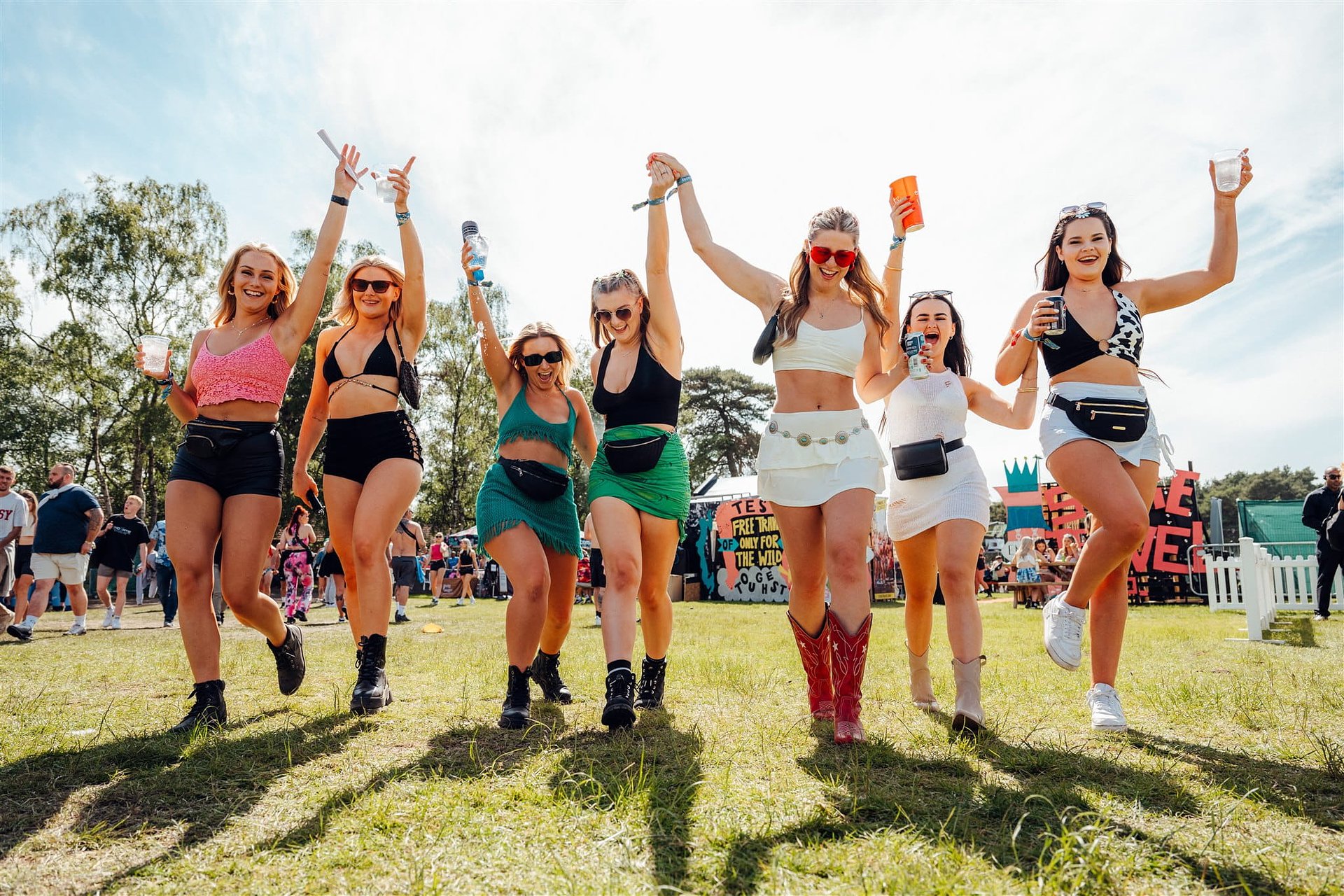 Group of girls dance in the sun at Bournemouth 7s Festival.