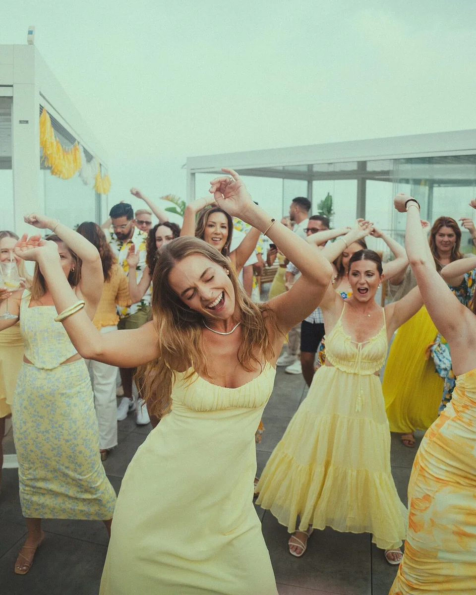 Travelers in yellow dancing at the Limoncello theme party