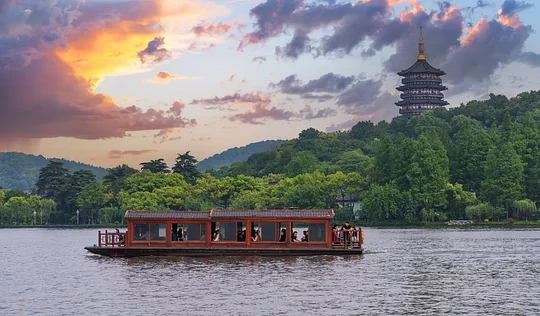 Float past pagodas and willow trees on West Lake