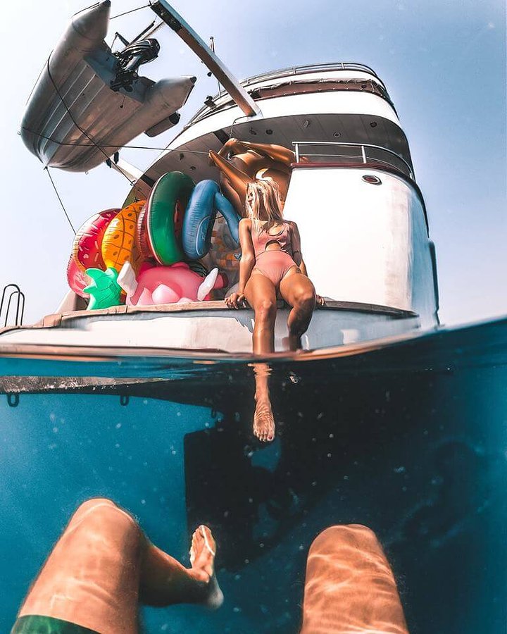 half underwater shot of a girl and a yacht croatia party boat