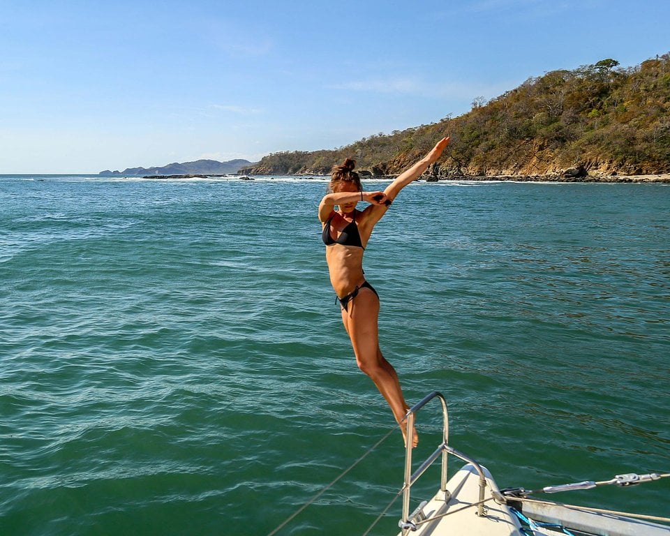 A traveler jumping off a boat into the sea off the coast of Nicaragua