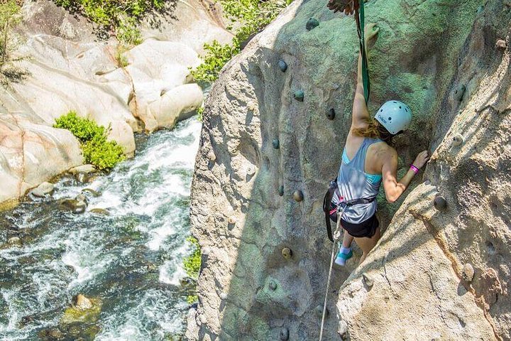 girl rock climbing with a river below tamarindo costa rica vacations