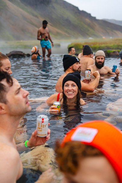 SurfYogaBeer group in a geothermal hot spring in Iceland