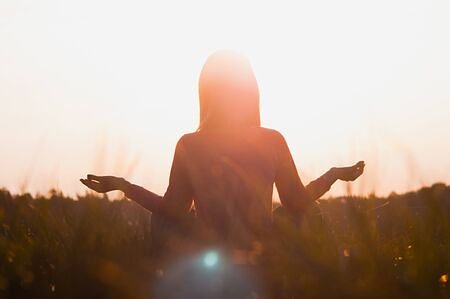 127333886backlightofawomanexercisingyogaatsunsetwithawarmthbackground