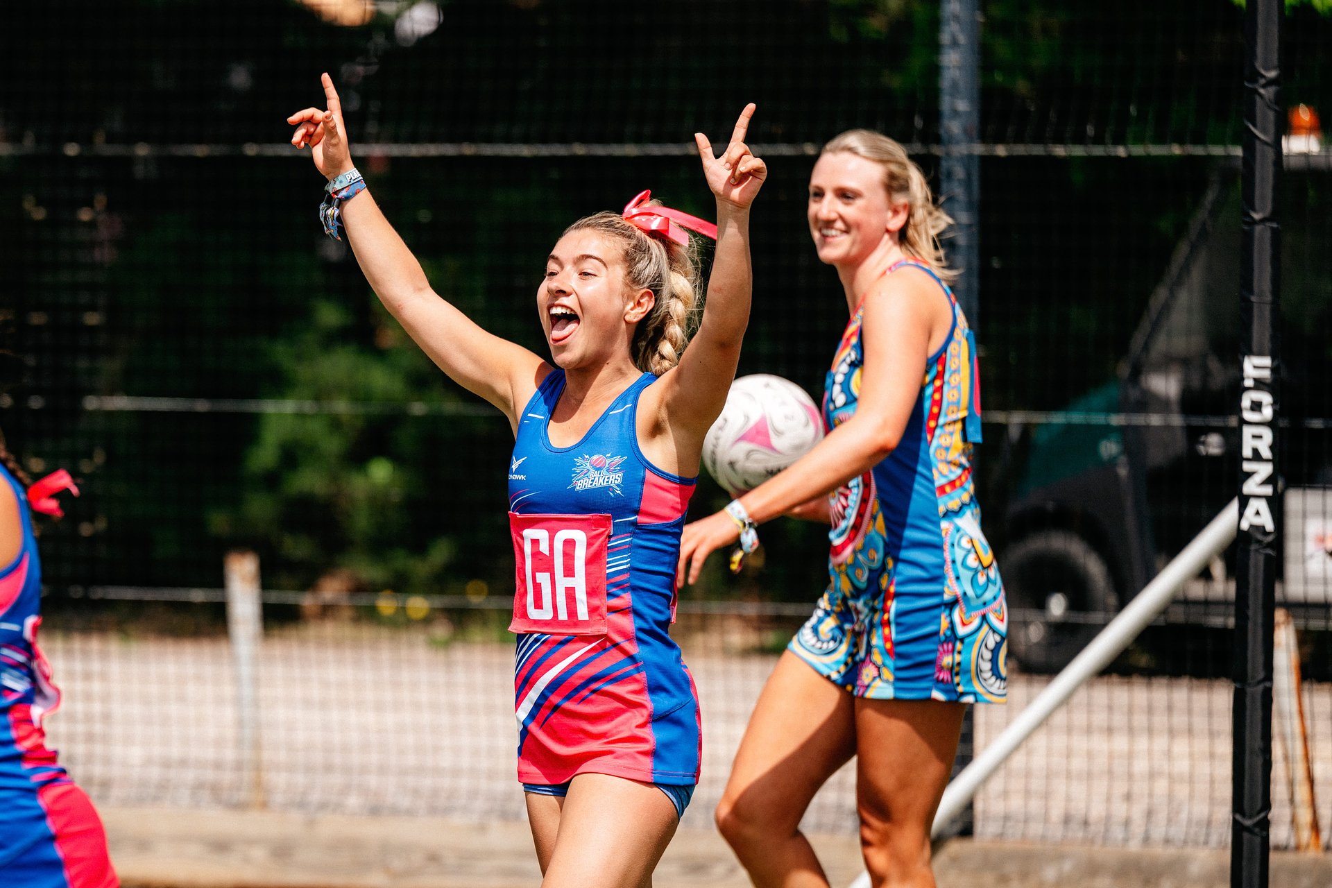 Women's netball player celebrating on the court at Bournemouth 7s Festival, in Dorset England