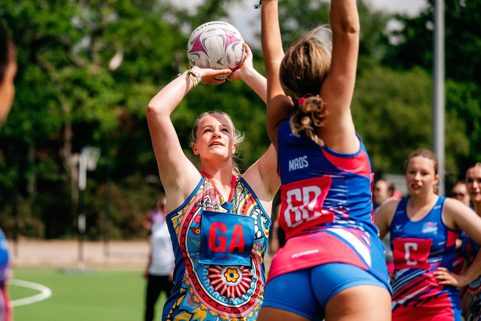 netball player taking a shot with the ball at Bournemouth 7s Festival, in Dorset England.