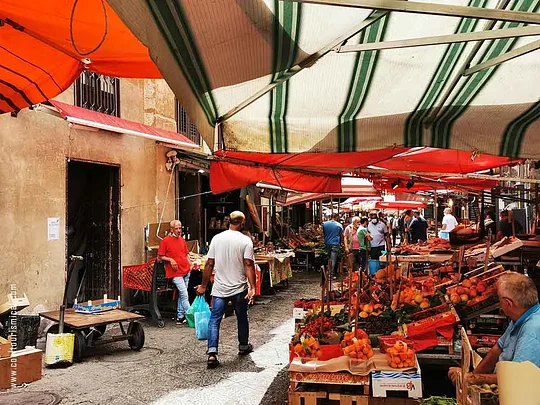 Explore the local market sampling iconic Sicilian street food