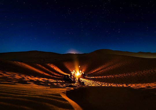 Stargaze in the open desert after nightfall
