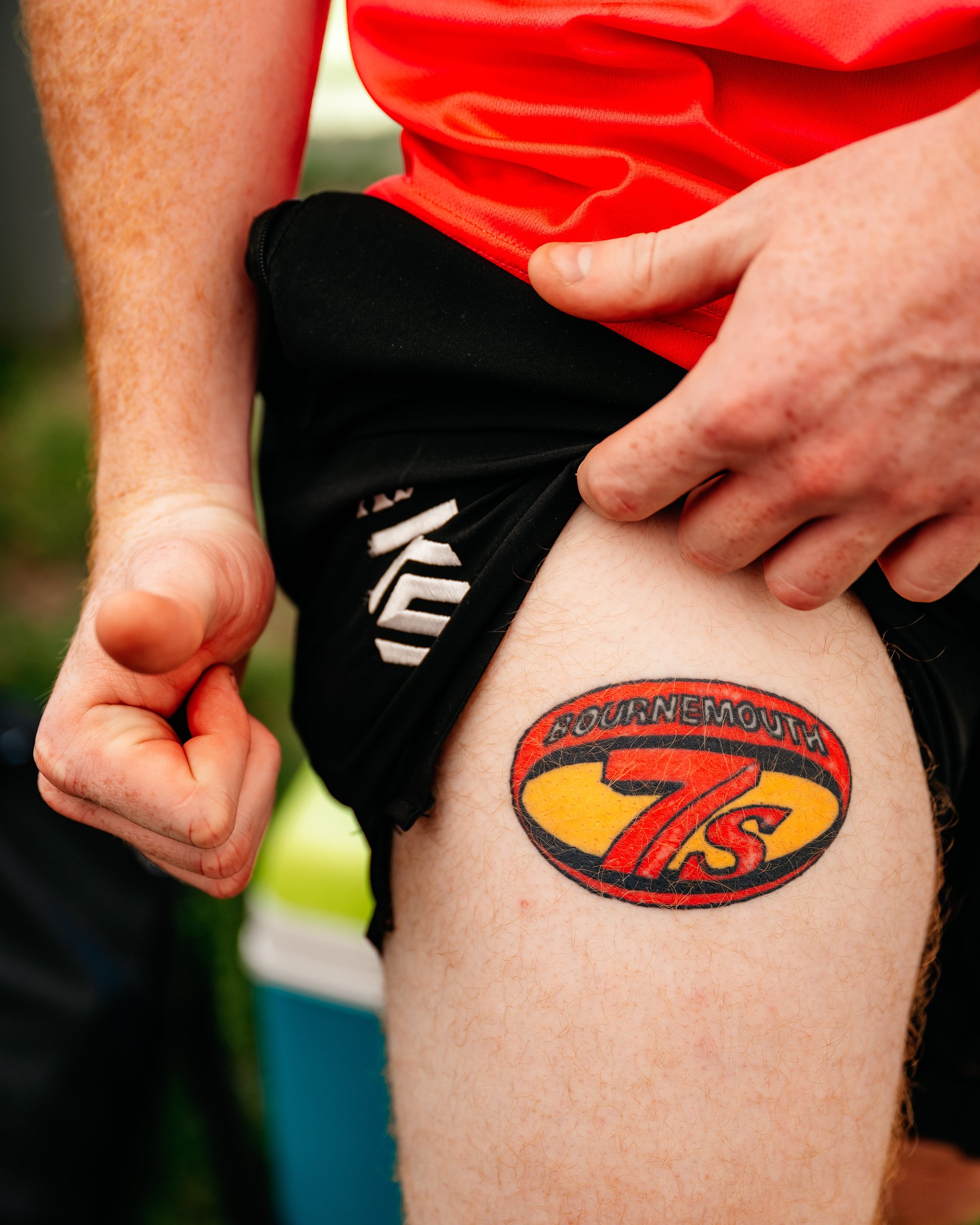Bournemouth 7s Festival tattoo on the leg in full colour of a rugby player doing a thumbs up.