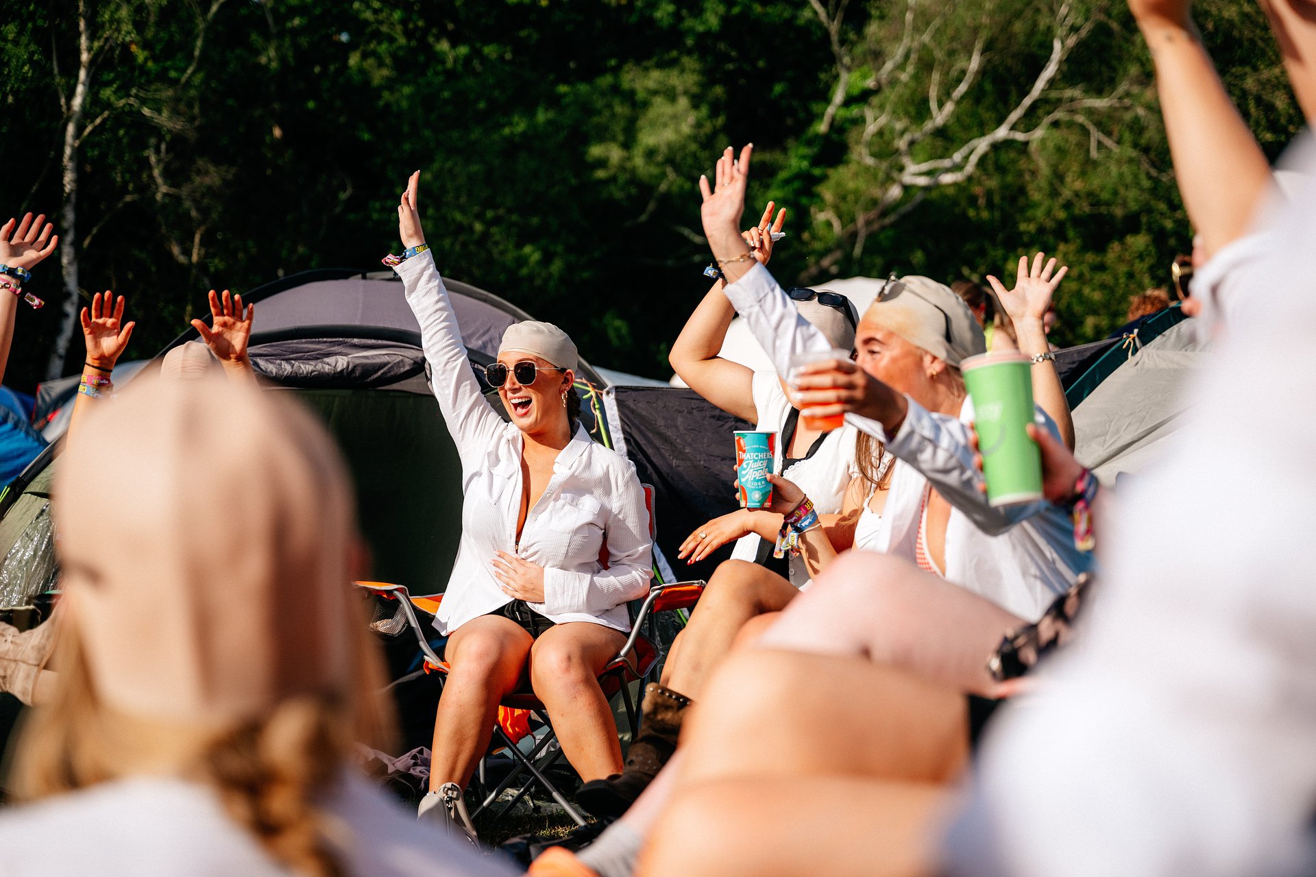 Candid group of girls having pre-drinks in the campsite dressed as Pitbull at Bournemouth 7s Festival