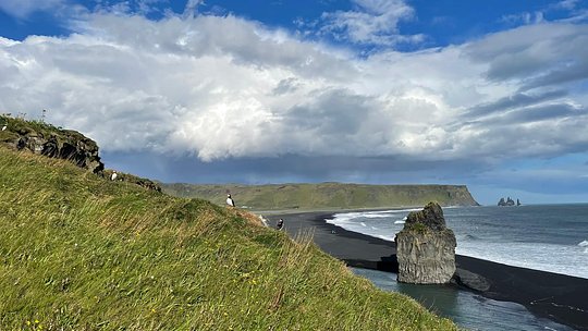 Discover Reynisfjara black sand beach and basalt stacks