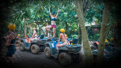 SurfYogaBeer group riding ATVs through the Bali jungle
