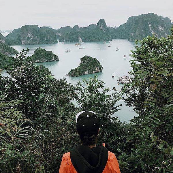 Male solo traveller overlooking Halong Bay vietnam