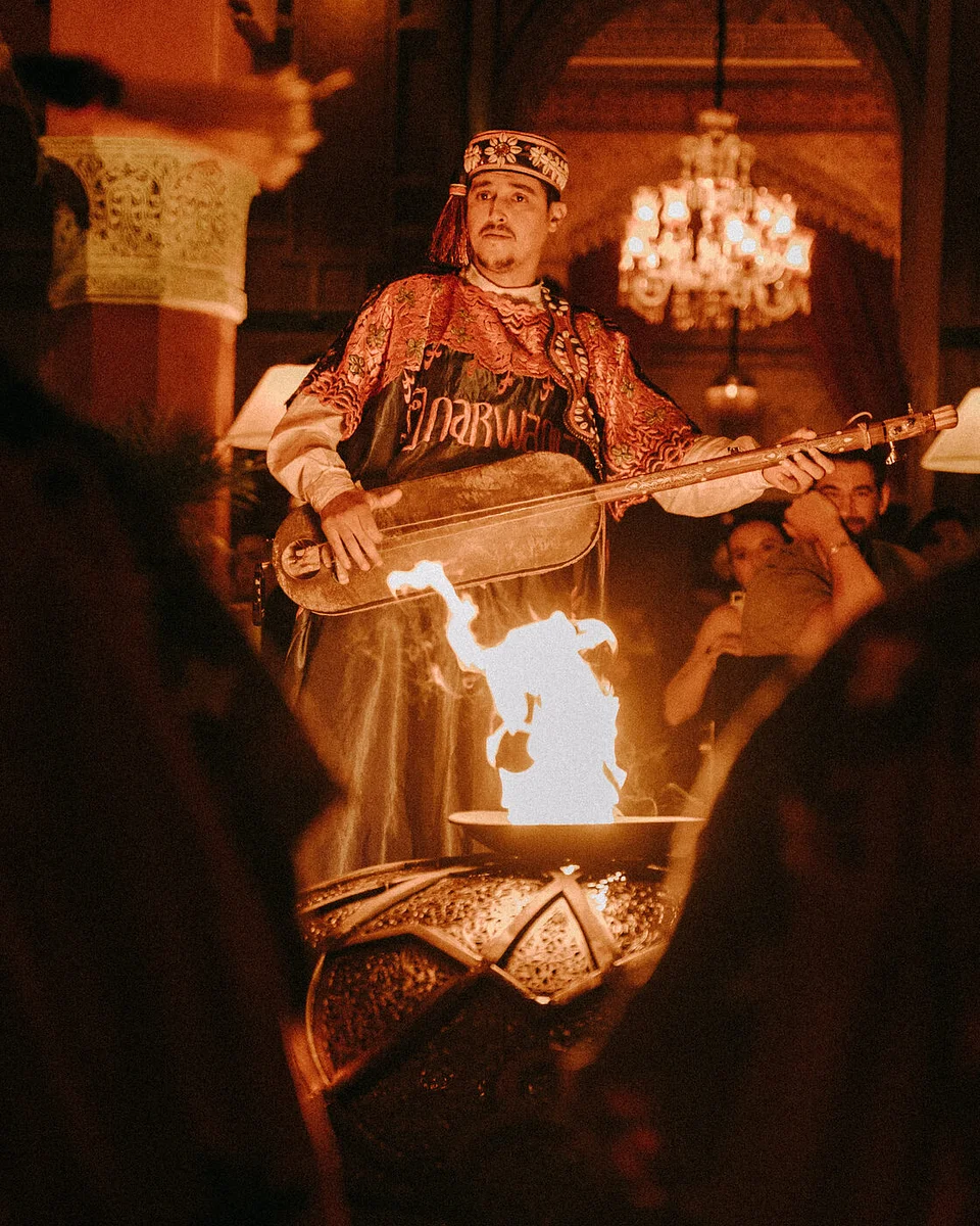 A Gnawa musician playing a stringed instrument