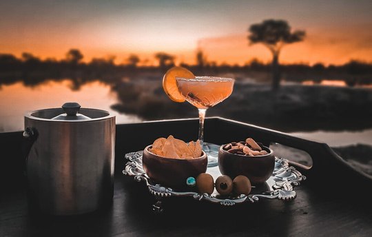 Sip sundowners with your new mates in the bush