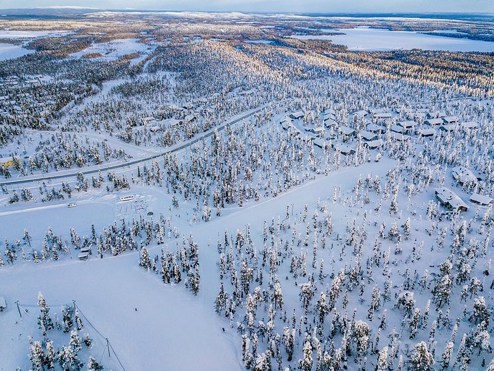 aerialviewofsnowcoveredwinterforestandroad20250318153142utc