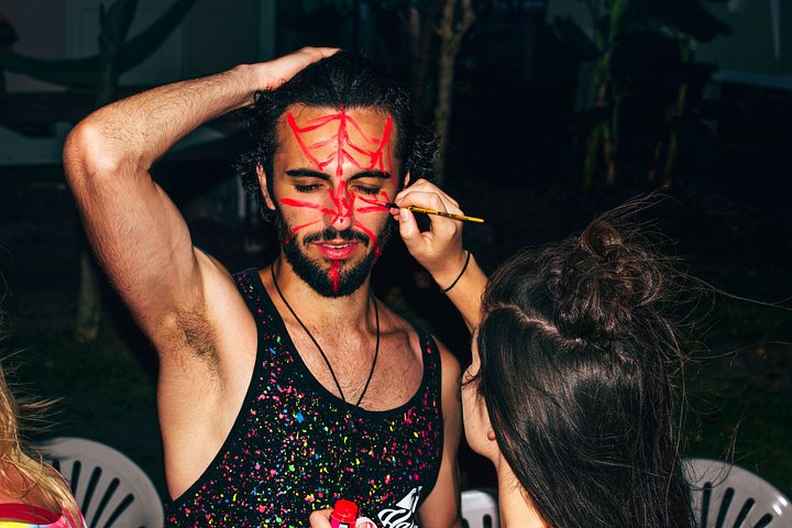 full moon party_male traveller getting face painted