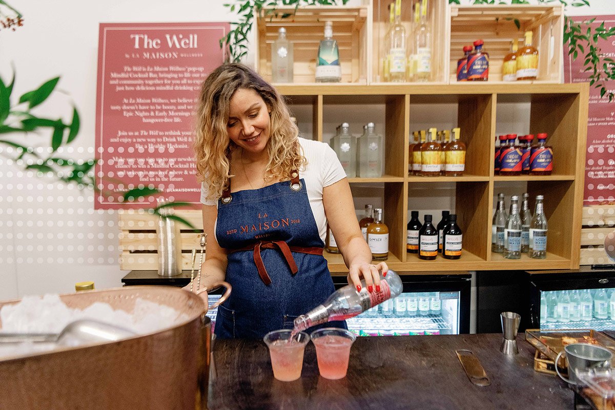 Woman serving drinks at balance festival in london
